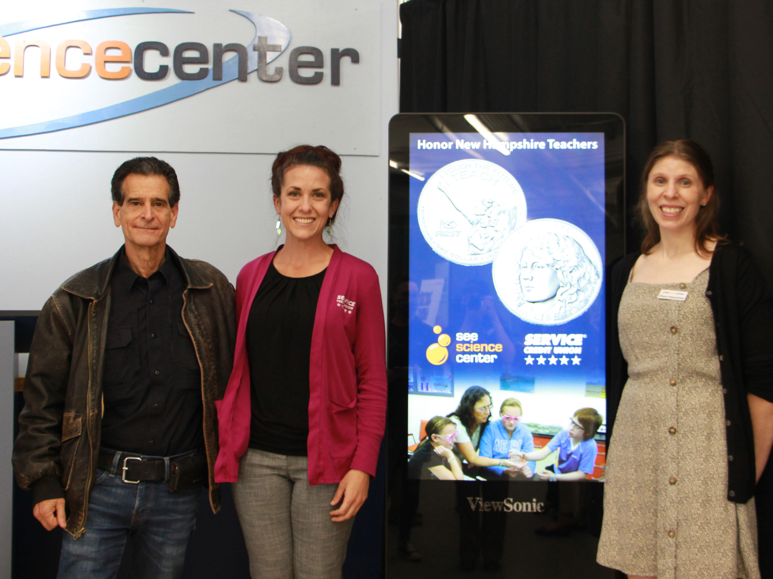 Dean Kamen and Jamie Yates representing sponsor Service Credit union poses with SEE director Shana Hawrylchak at the program launch.