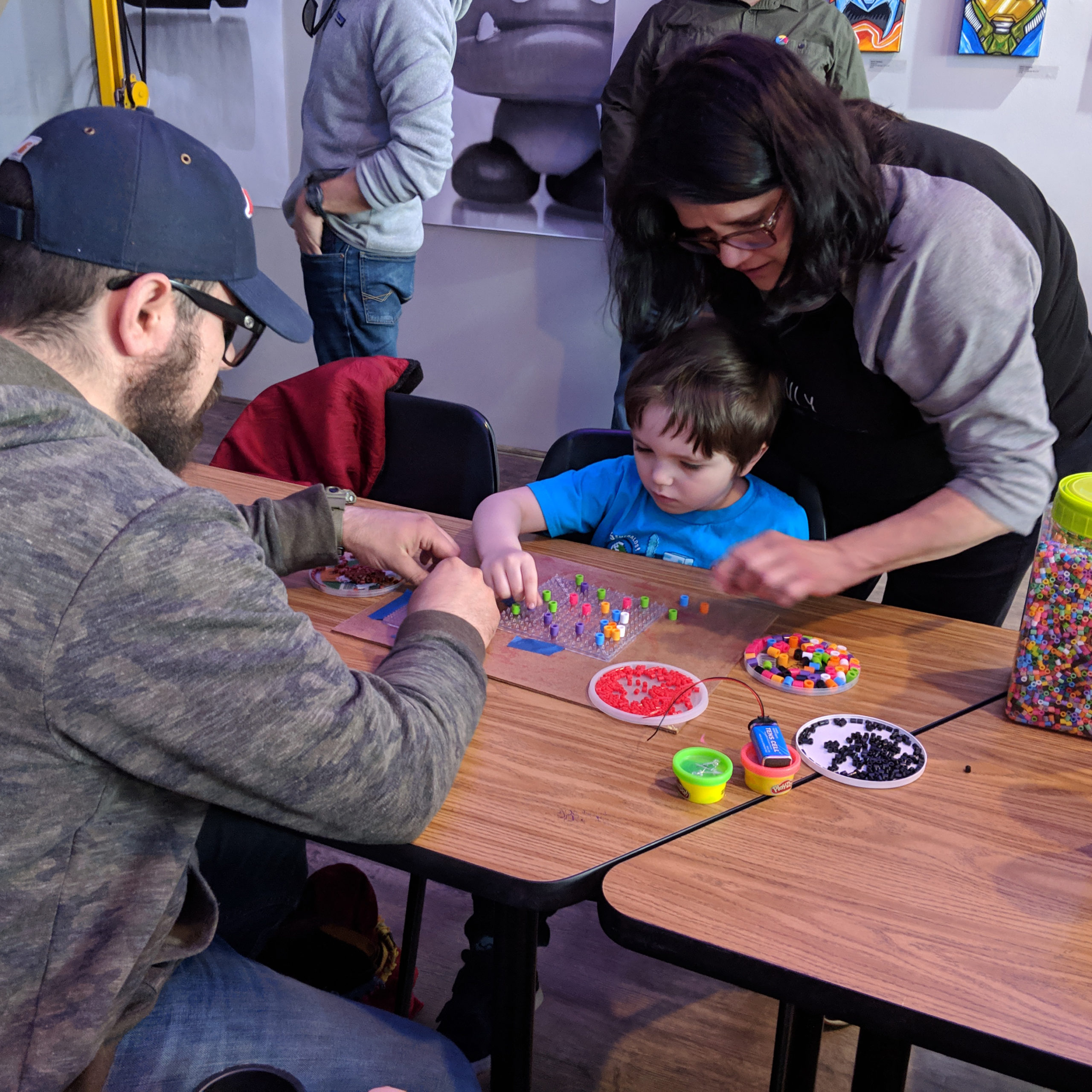 a family makes art together at a Ralph Baer event