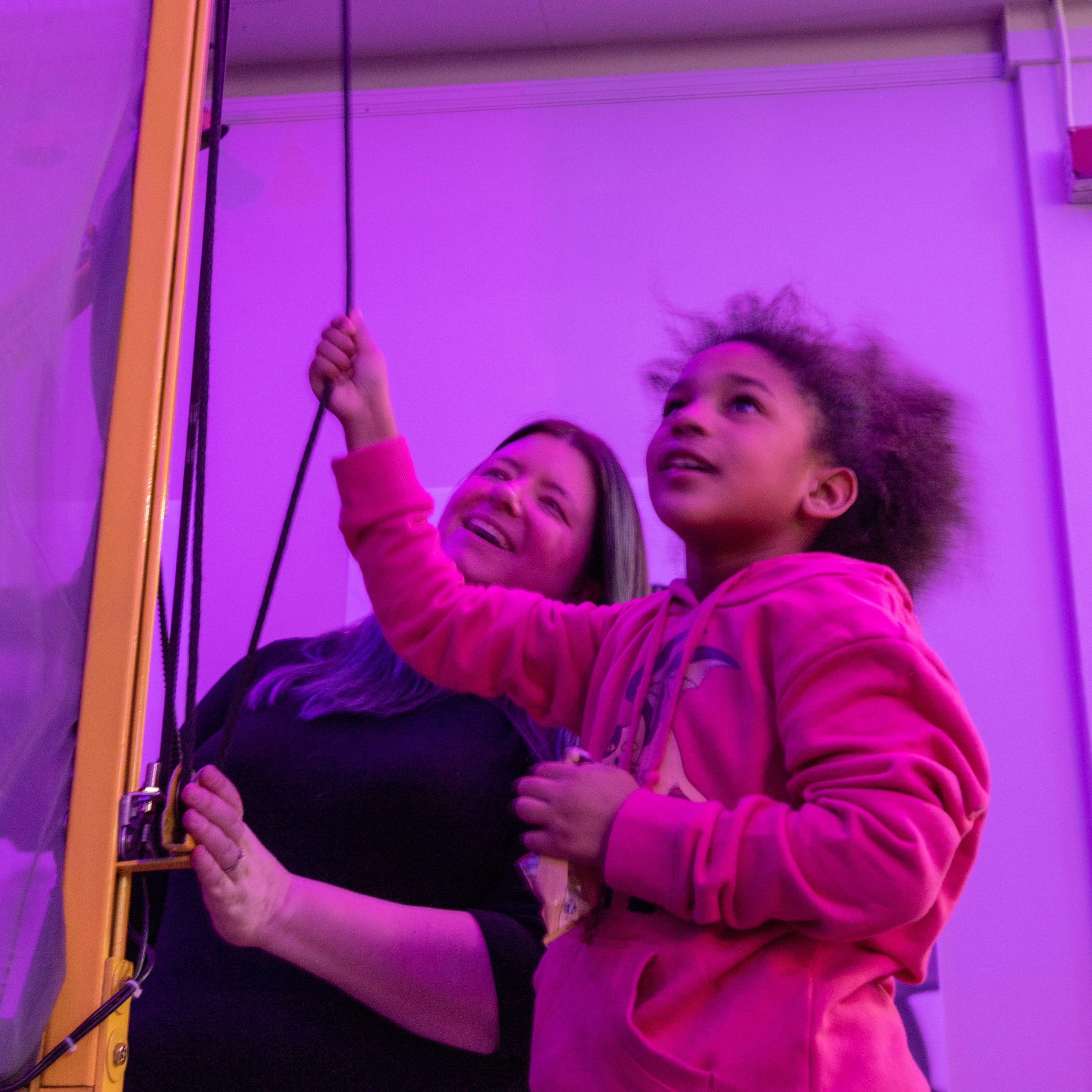 A woman and girl use an interactive exhibit at a Ralph Baer event