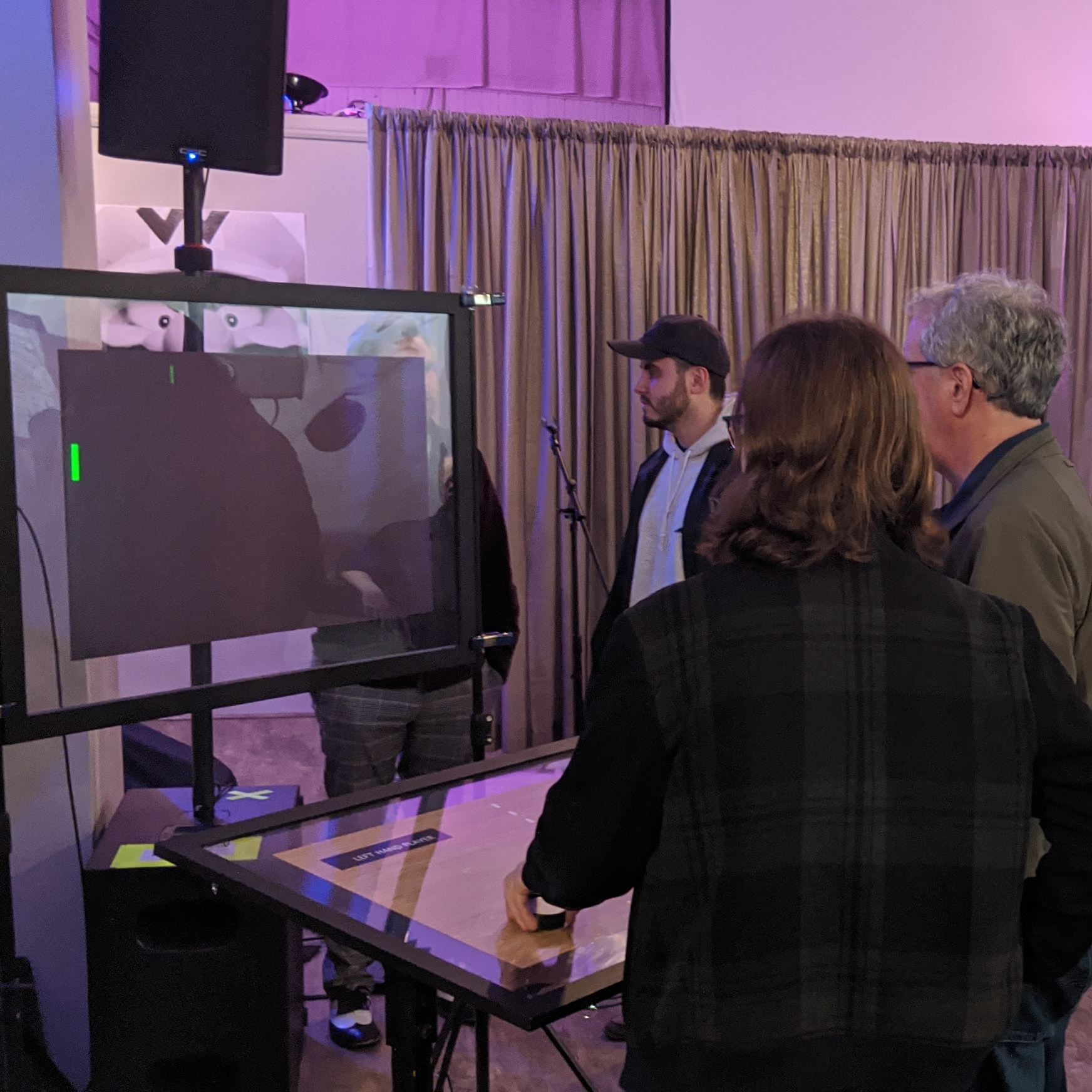 People use an interactive exhibit at a Ralph Baer event