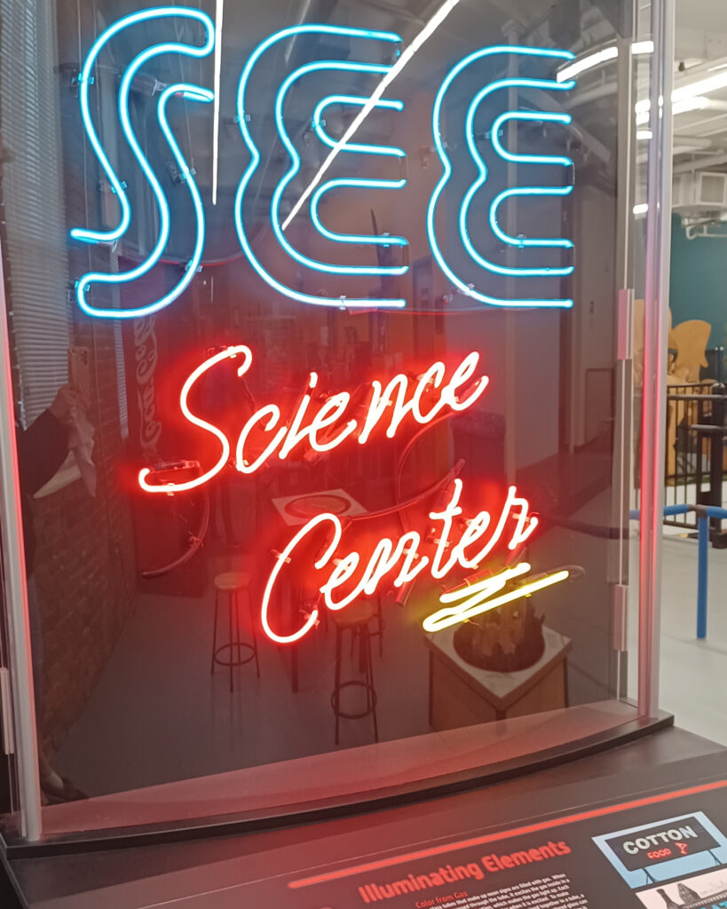 Neon Sign reading SEE Science Center