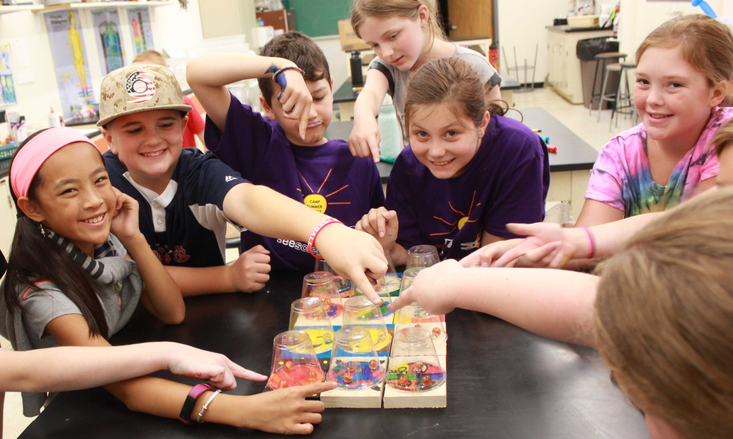 A group of campers show of the games they made.