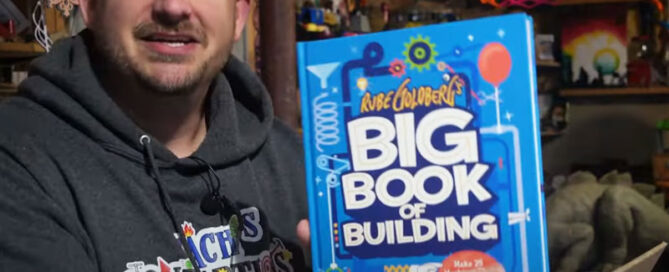 Zach Umperovich holding Rube Goldberg's big book of building