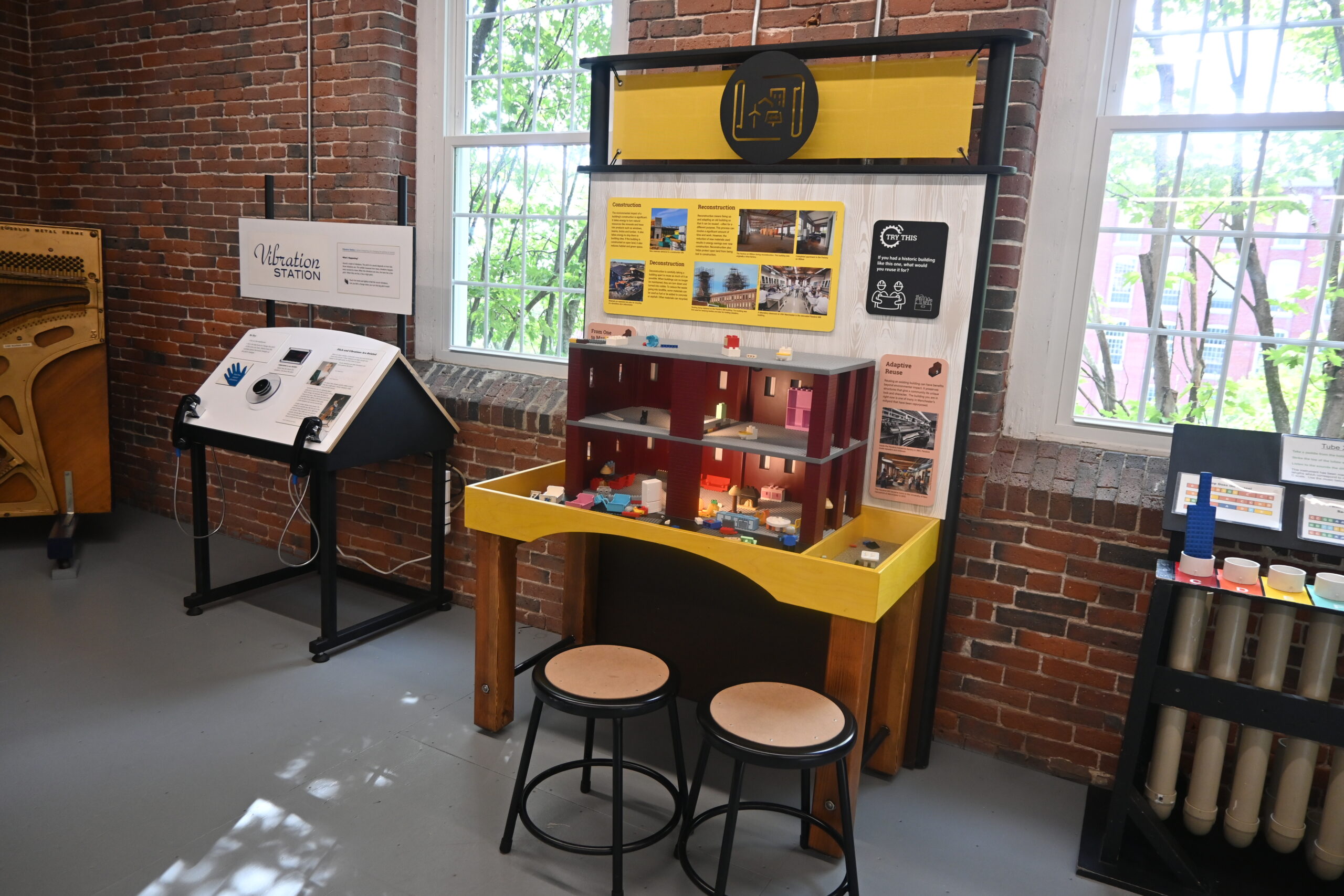 A LEGO size building on a table where visitors can build what they want inside.