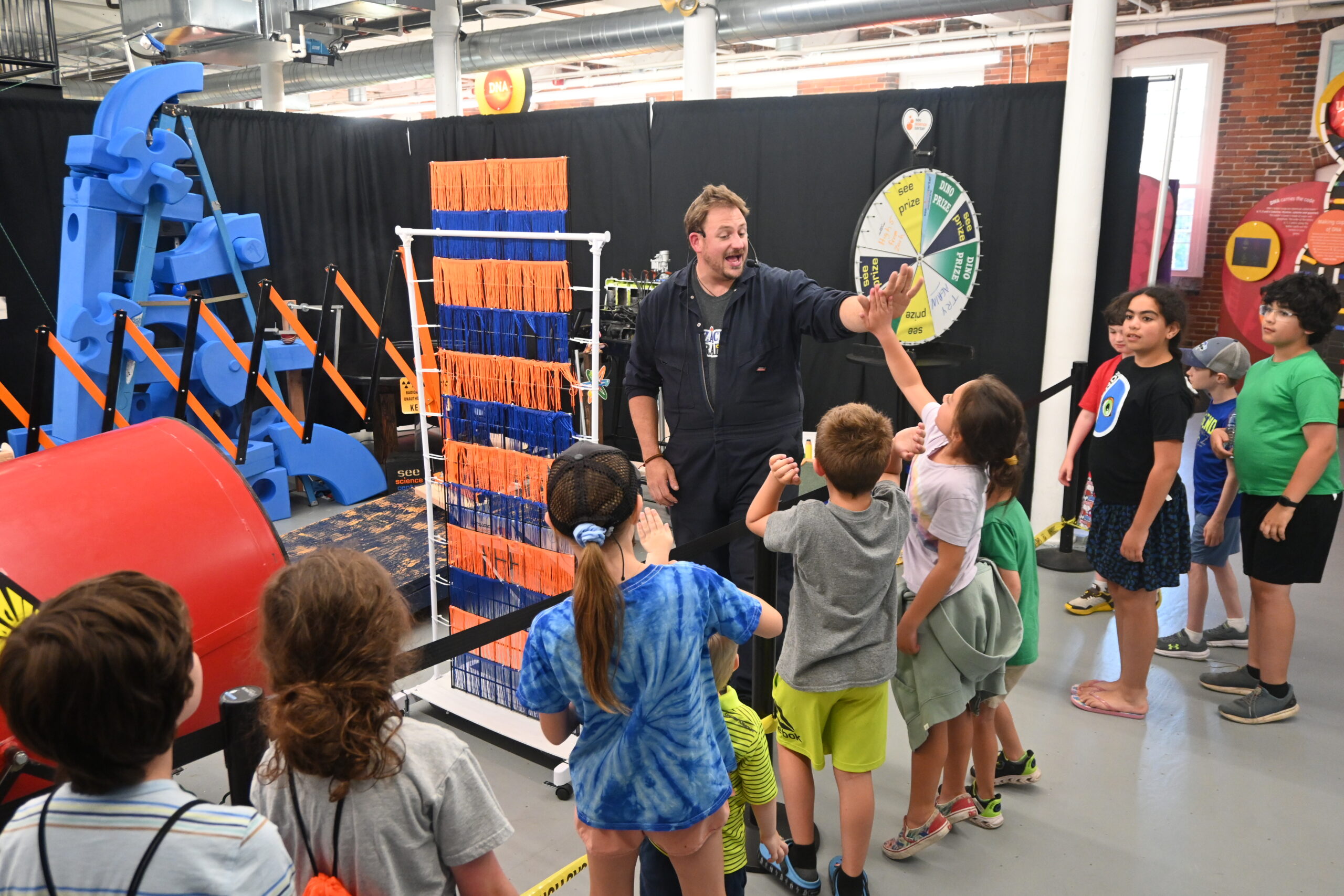 Zach High fives spectators who watched the contraption give them prizes in 2024