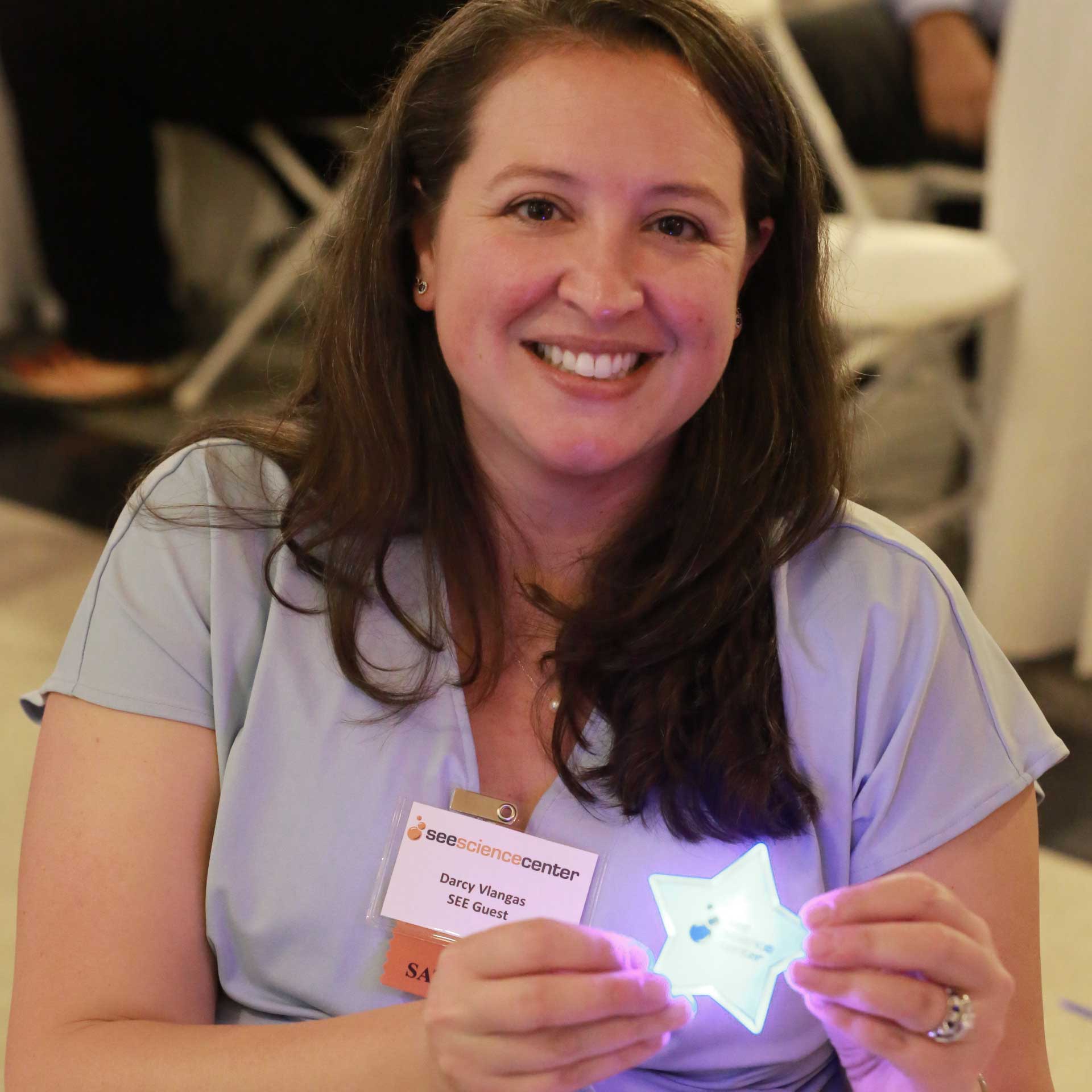 a woman show off her donation star button